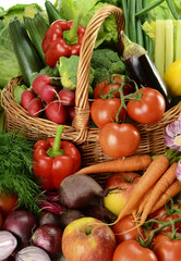 Composition with raw vegetables and wicker basket