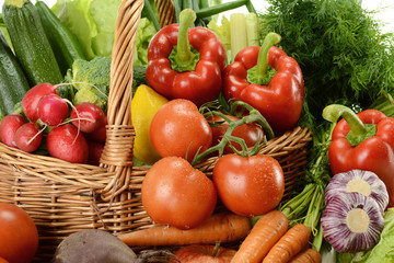 Composition with raw vegetables and wicker basket