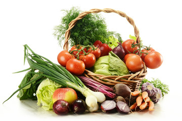 Composition with raw vegetables and wicker basket