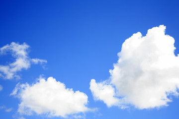 Fluffy white clouds in blue sky