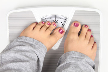 Woman’ s feet on bathroom scale