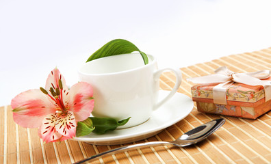 White cup with pink flowers