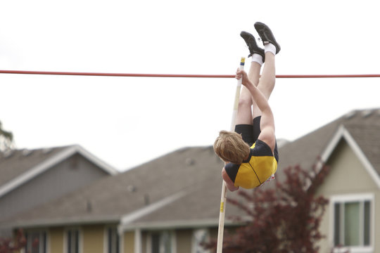 Male athlete competing in the pole vault