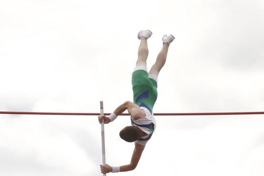 Male athlete competing in the pole vault