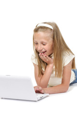 Happy and smiling little girl with laptop