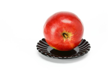 Red apple on black plate