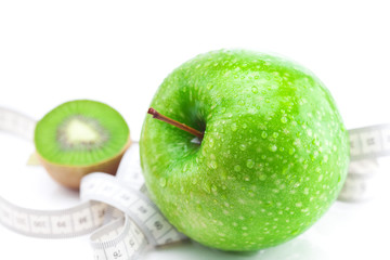apple,kiwi and measure tape isolated on white