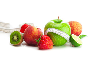 big juicy red ripe strawberries,apple,lime,peach,kiwi  and measu