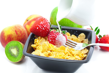 strawberry, peach, apple, kiwi, fork, milk and flakes in a bowl