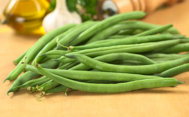 Fresh raw green beans on wooden board