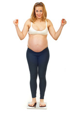 Cheering pregnant woman on scale