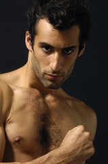 young sensual man on a black background