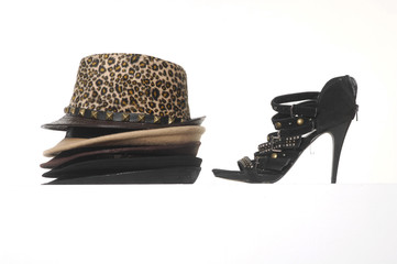 Close up Stacks of straw hats and high heel black shoes