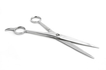 Open pair of scissors isolated over white