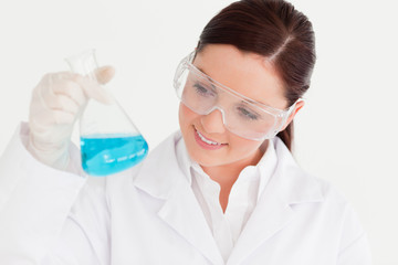 Fototapeta premium Good looking scientist holding a beaker in a laboratory