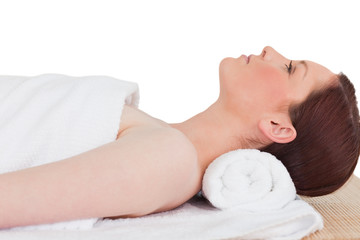 Fototapeta na wymiar Closeup of a cute serene woman posing while relaxing in a spa ce