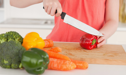 Woman cutting some vegetables in the kitchen