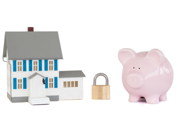 House locked with padlock and pink piggy bank