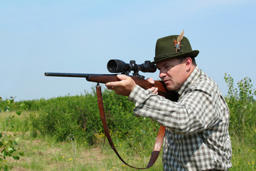 Fototapeta premium hunter aiming with sniper rifle