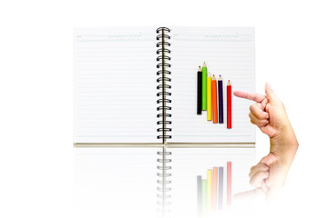 White book with crayons at hand, pointing a white background