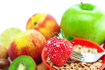 strawberry, peach, apple, kiwi, fork, milk and flakes in a bowl