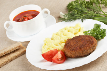 Cutlet with mashed potatoes and soup