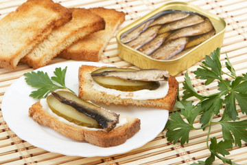 Sandwiches with sprats and ingredients to them