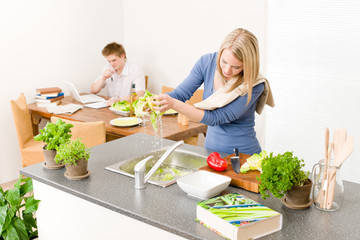 Lunch young woman cook salad wash lettuce
