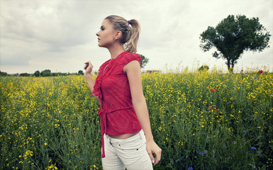 Young woman relaxing on a green meadow - obrazy, fototapety, plakaty