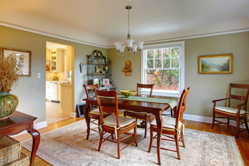 Green dining room with mahogany furniture