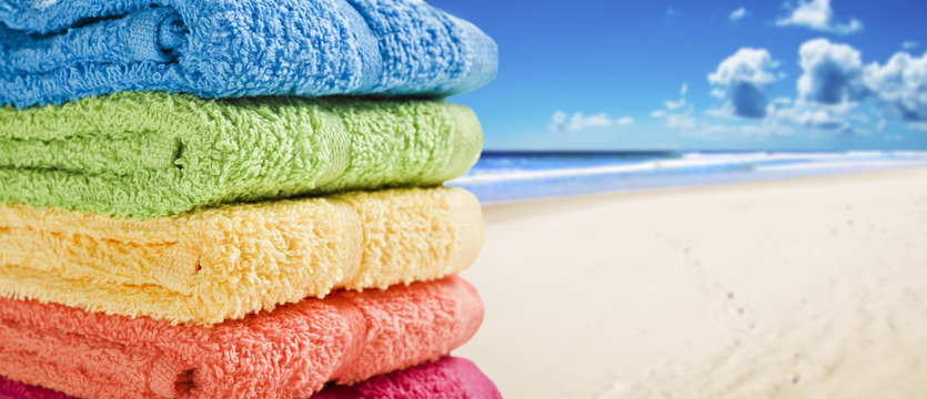 Colorful Towels On A White Beach