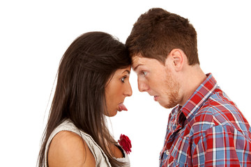 woman sticking out her tongue at man