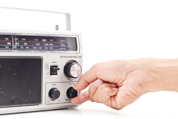 Hand Turning Up the Volume on Vintage AM FM Radio