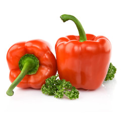 Two Red Peppers decorated with greenery