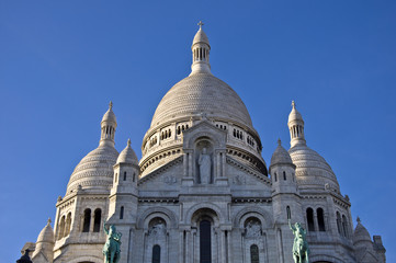 Fototapeta premium Basilica of Sacre Coeur in Paris. Against the blue sky.