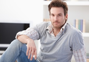 Fototapeta premium Casual man sitting on floor at home