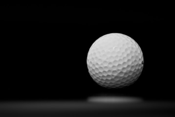 Golf ball in black background