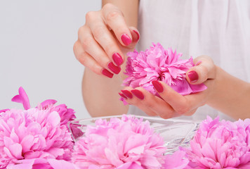 Manicure spa pampering with pink peony flowers