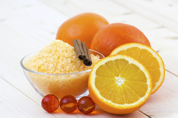 bowl of orange bath salt with fresh fruits - beauty treatment