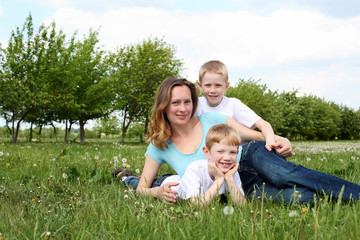 Fototapeta premium mother with her two sons outdoors