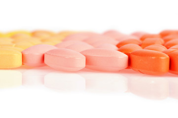 Stack of different pills isolated on white background