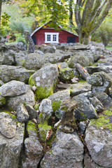 Stone wall with red barn
