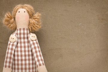 Toy girl on old brown background