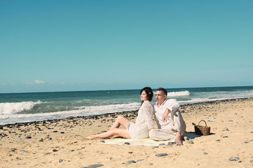 Fototapeta na wymiar couple sit down on the beach