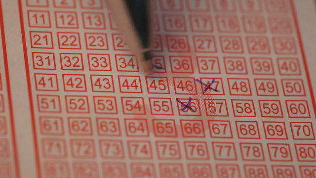 Female hands filling lottery ticke