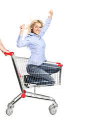 Smiling woman riding in a shopping cart