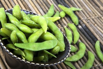 Edamame soy beans in a brown ceramic dish