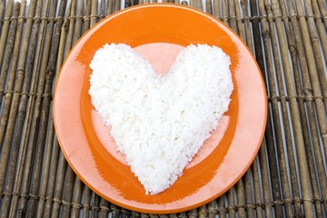 Heart shaped white rice on a ceramic plate