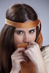 Woman hidding behind a necktie
