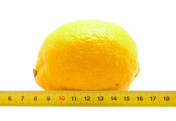 Lemon and ruler on a white background